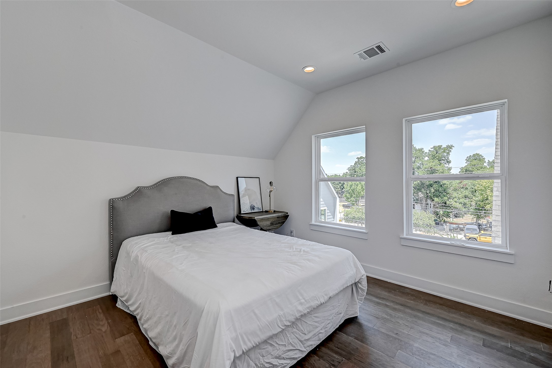 6022 Beall Street Houston, TX 77091 - Photo 16 of 18 This tranquil guest suite boasts rich wood flooring, vaulted ceilings, and dual windows that overlook the peaceful neighborhood below.