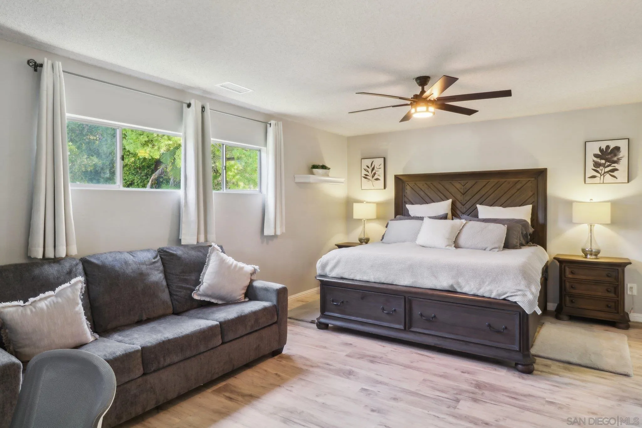 10420 Loma Rancho Drive Spring Valley, CA 91978 - Photo 11 of 41 a spacious bedroom with a bed couch and window