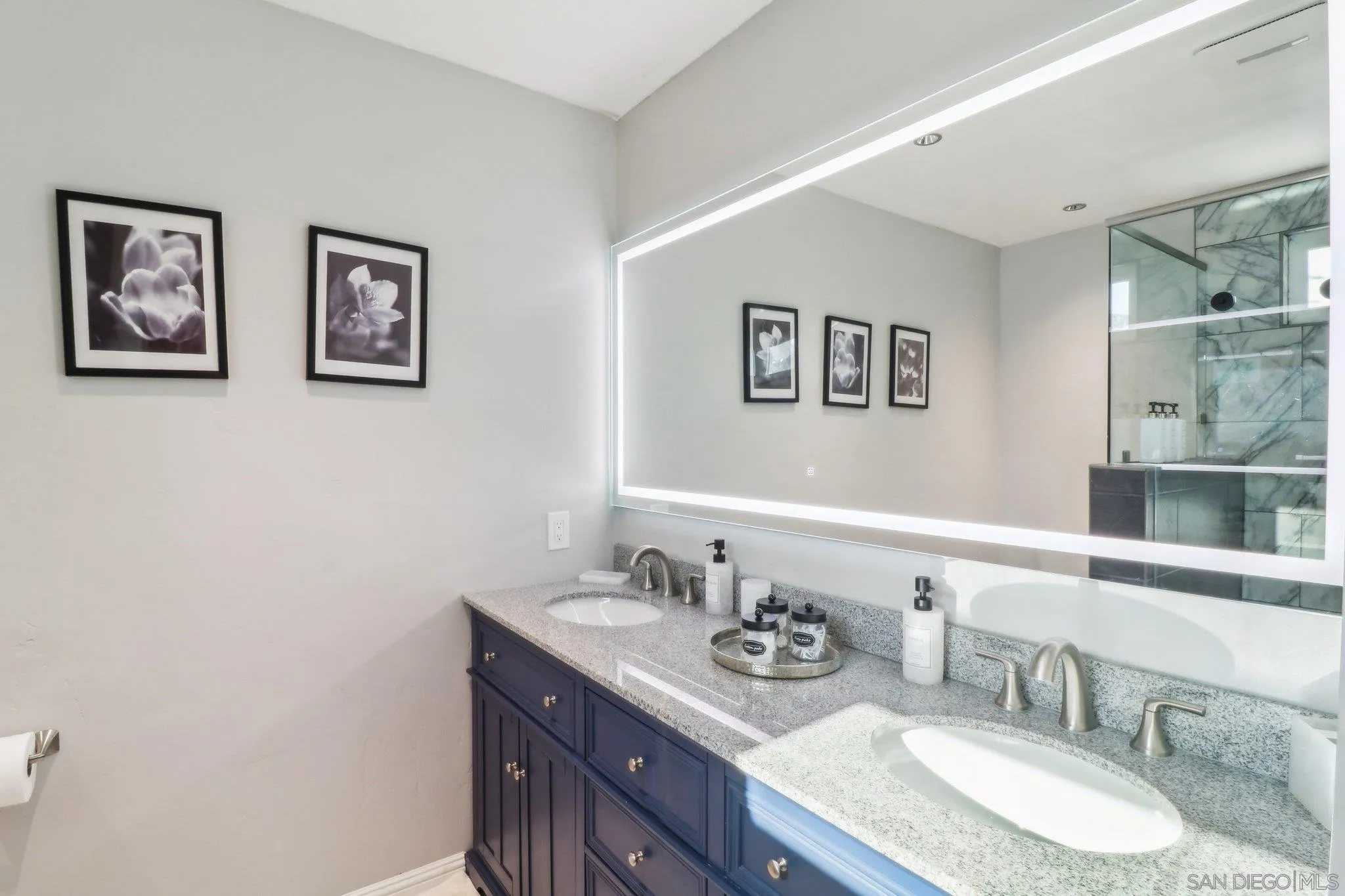 10420 Loma Rancho Drive Spring Valley, CA 91978 - Photo 14 of 41 a bathroom with a granite countertop sink a mirror and a picture on the wall