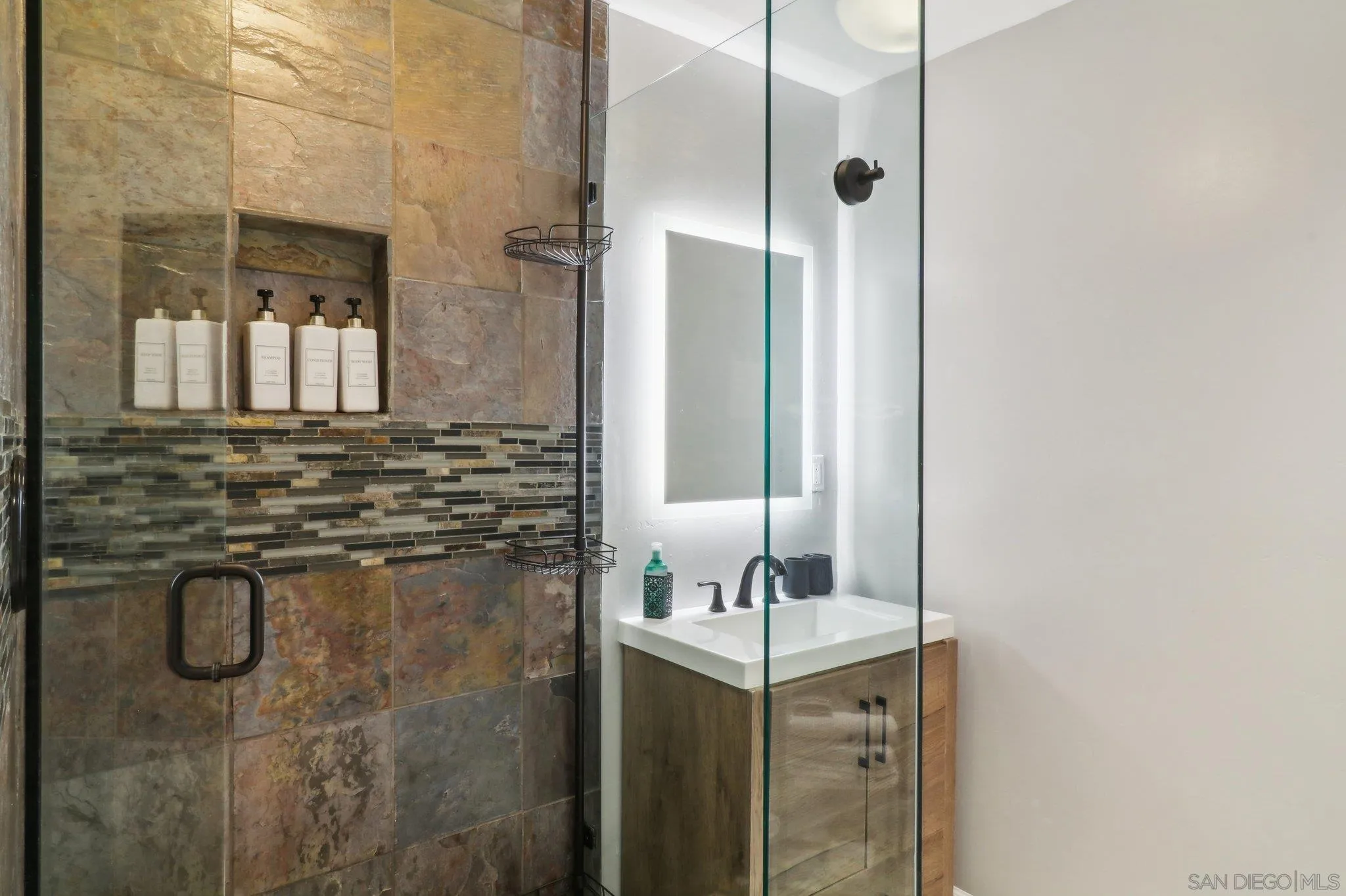 10420 Loma Rancho Drive Spring Valley, CA 91978 - Photo 19 of 41 a bathroom with a shower sink and mirror