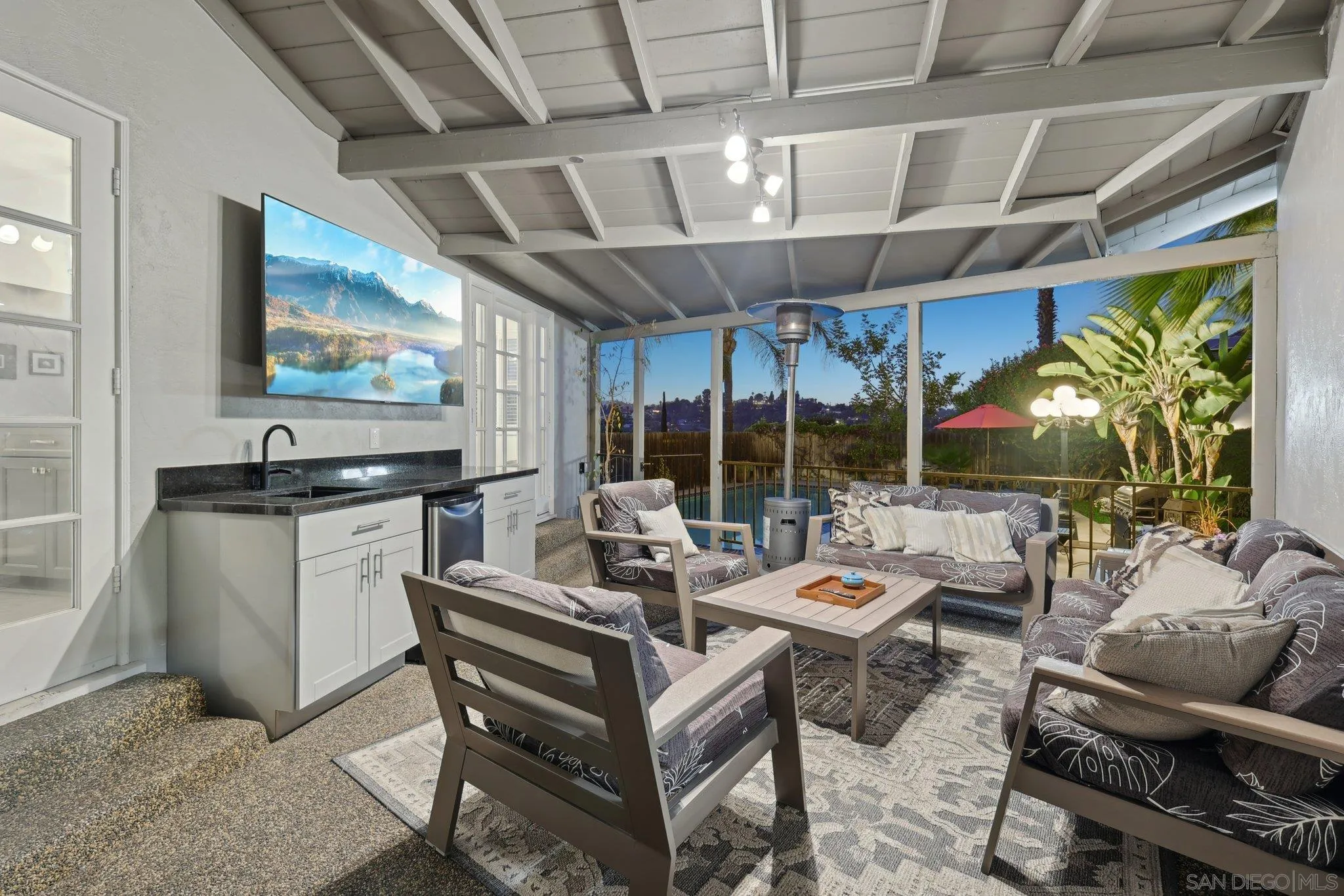 10420 Loma Rancho Drive Spring Valley, CA 91978 - Photo 8 of 41 a living room with patio furniture and a flat screen tv