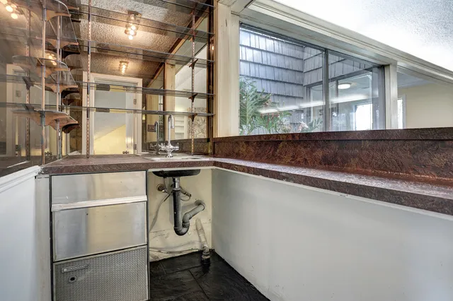 a kitchen with a refrigerator and window