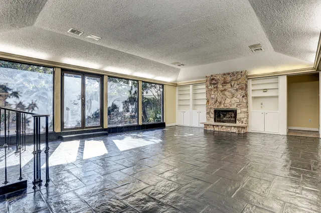 a view of an entryway with floor to ceiling window and wooden floor