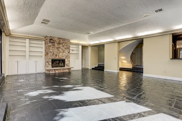 a living room with fireplace furniture and a wooden floor