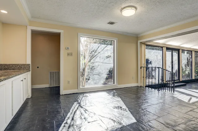 a view of an entryway with wooden floor and door in a room