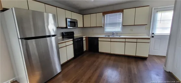 a kitchen with stainless steel appliances a refrigerator sink and microwave