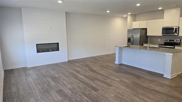 a kitchen with stainless steel appliances a refrigerator sink and microwave