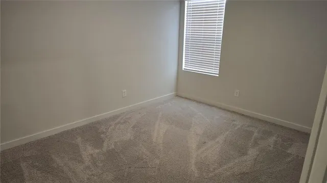 a view of an empty room with windows