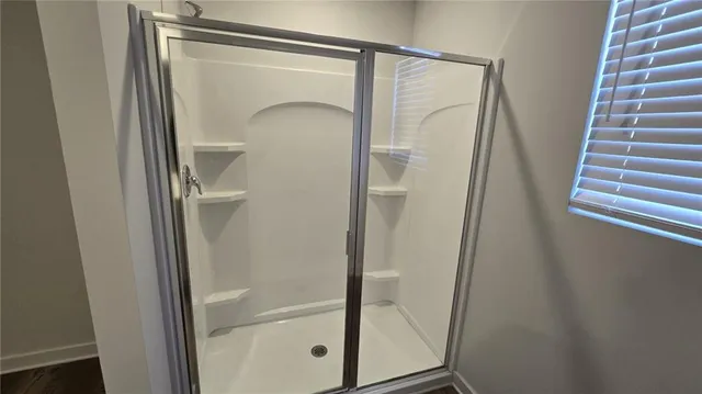 a bathroom with a glass shower door