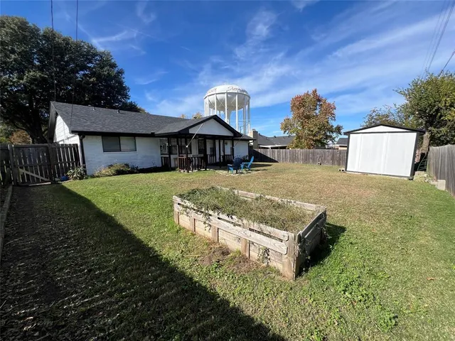 a view of a house with a yard and garage