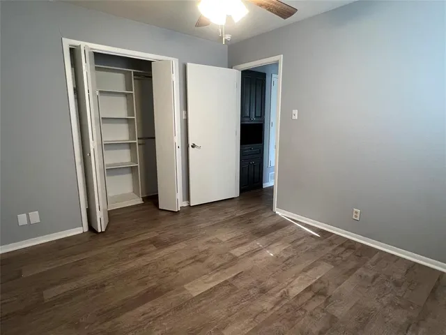 an empty room with closet and a window