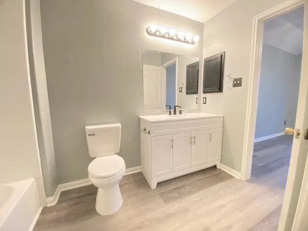 a bathroom with a toilet sink and mirror