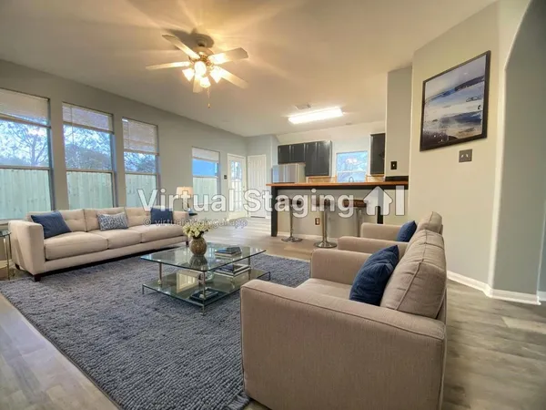 a living room with furniture and a large window