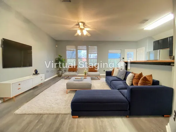 a living room with furniture and a flat screen tv