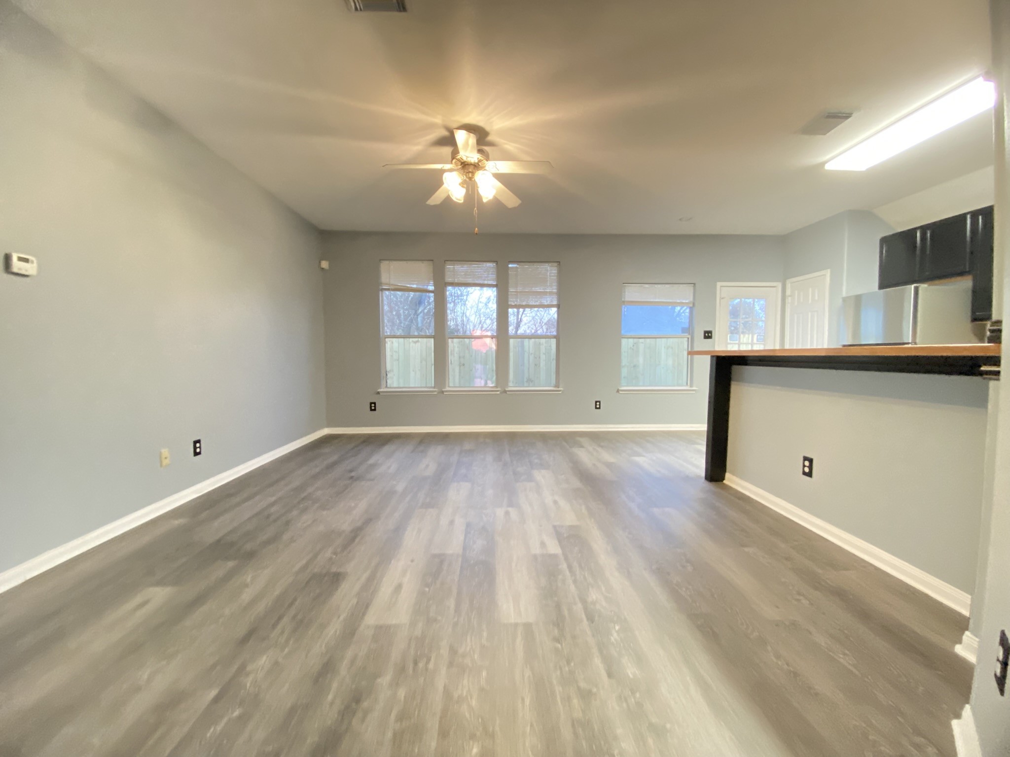 4031 Raspberry Court Dickinson, TX 77539 - Photo 8 of 24 wooden floor in an empty room with a window