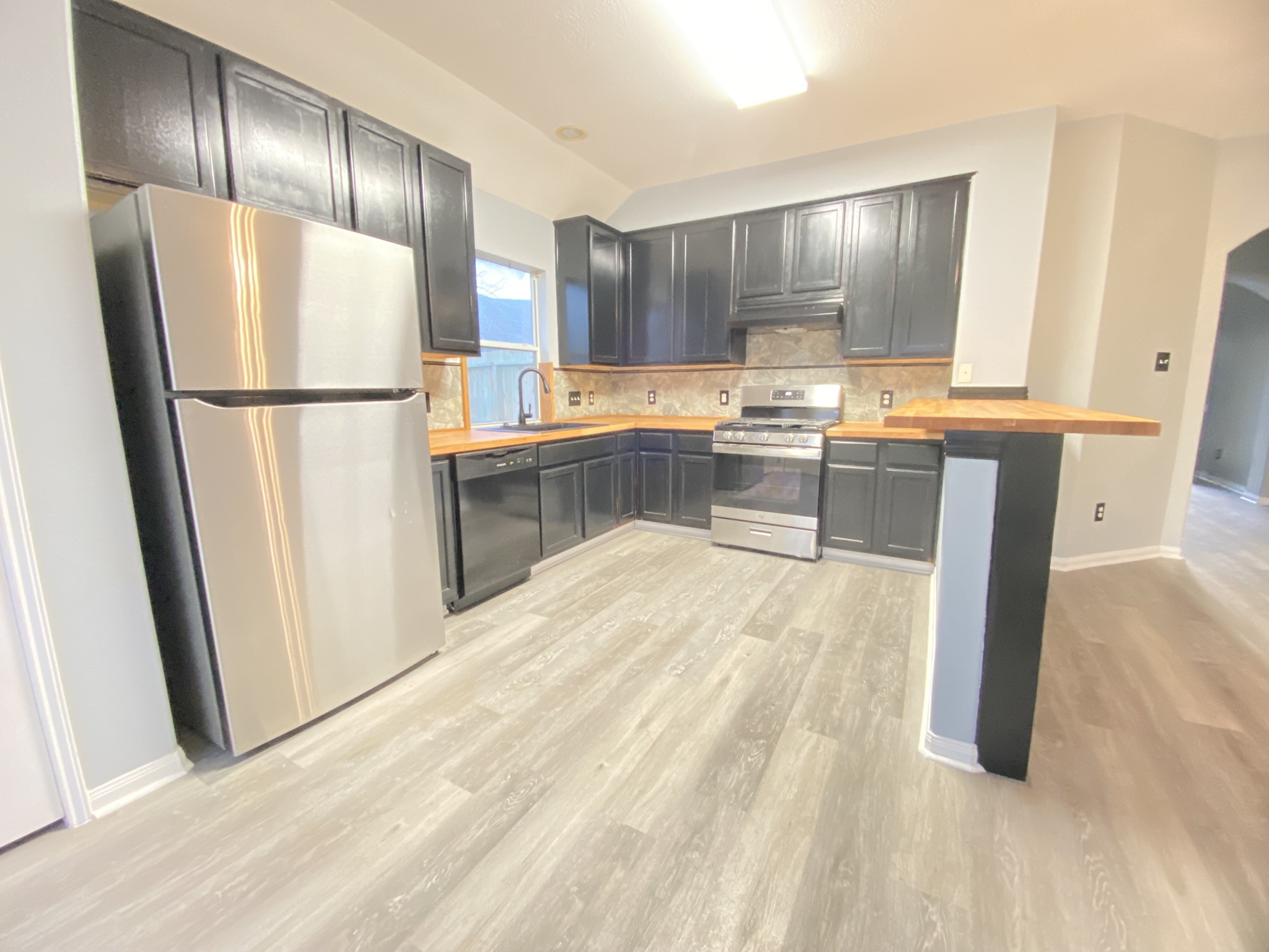 4031 Raspberry Court Dickinson, TX 77539 - Photo 9 of 24 a kitchen with granite countertop a refrigerator and a sink