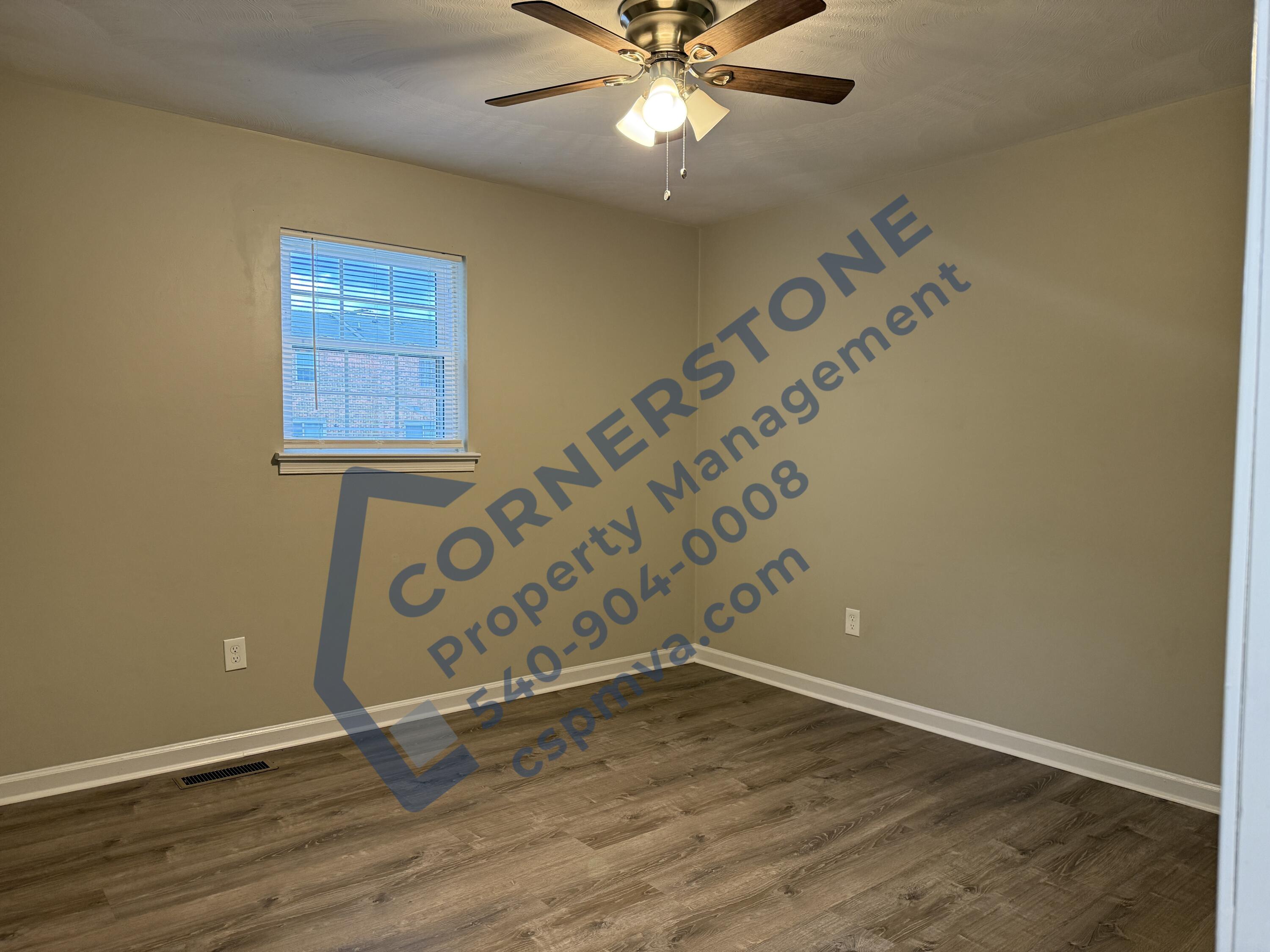 1609 19th Street Northeast, Unit 3 Roanoke, VA 24012 - Photo 7 of 12 an empty room with wooden floor and fan