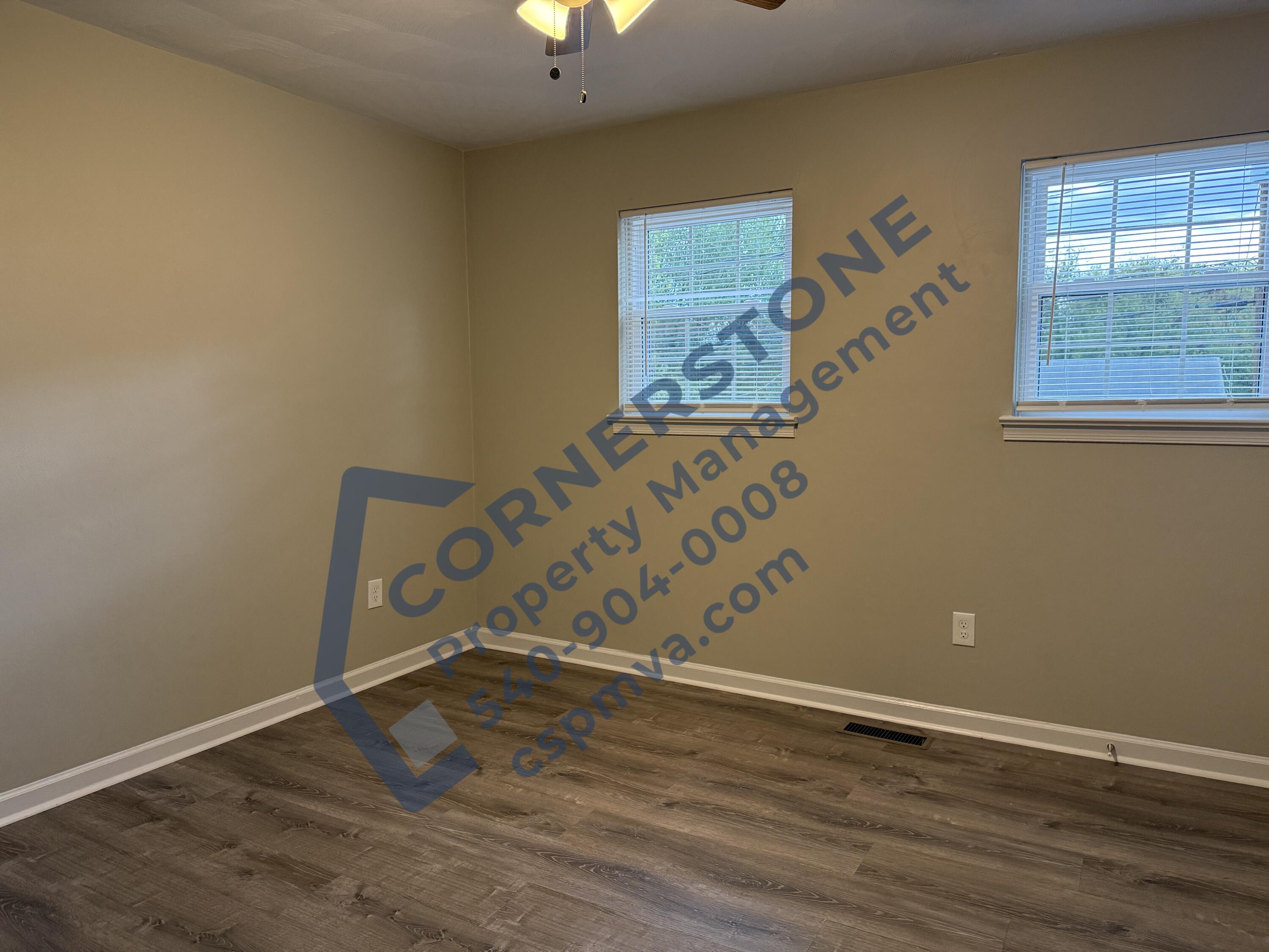 1609 19th Street Northeast, Unit 3 Roanoke, VA 24012 - Photo 10 of 12 a view of an empty room with wooden floor and a window