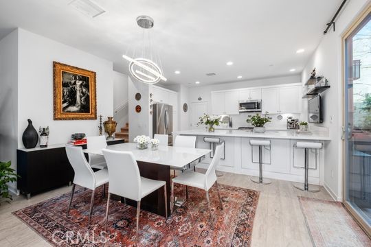 165 Frame Irvine, CA 92618 - Photo 11 of 37 a view of kitchen with refrigerator dining table and chairs