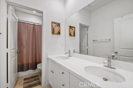 165 Frame Irvine, CA 92618 - Photo 32 of 37 a bathroom with a sink double vanity and a mirror