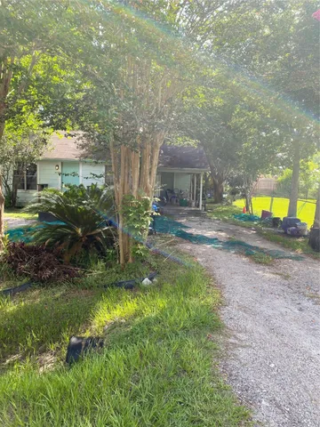 a view of a house with a yard and sitting area