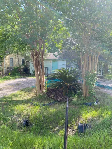 a view of backyard of house with green space