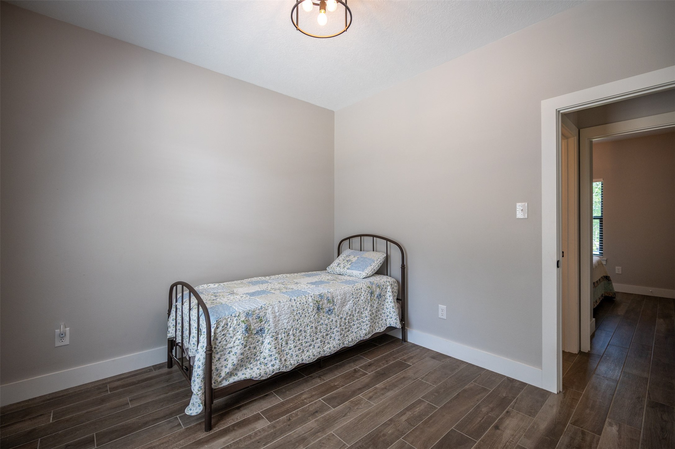 1068 County Road 3200 Colmesneil, TX 75938 - Photo 31 of 43 a bedroom with a bed and wooden floor