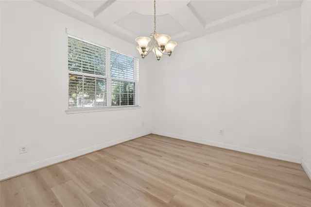 a large kitchen with stainless steel appliances kitchen island a large counter top and a wooden floors