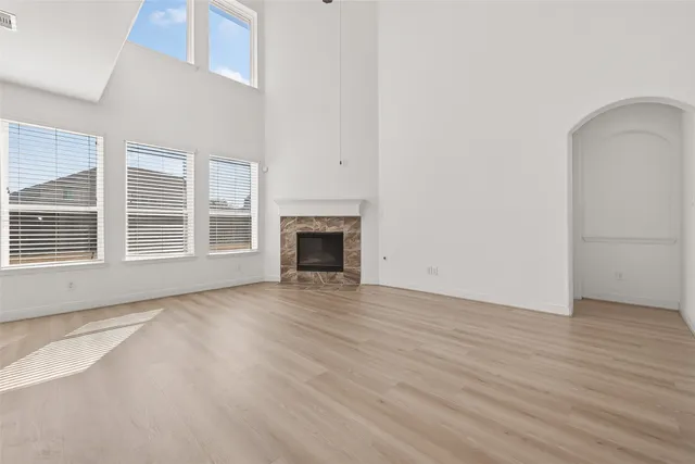 a view of kitchen with stainless steel appliances kitchen island wooden cabinets and fireplace