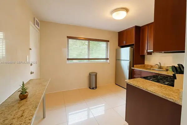 a kitchen with a sink and a stove top oven