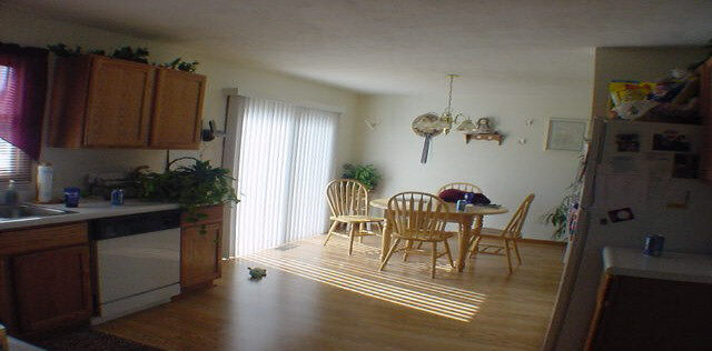 5431 Torque Road Loves Park, IL 61111 - Photo 3 of 5 a dining room with furniture a chandelier and wooden floor