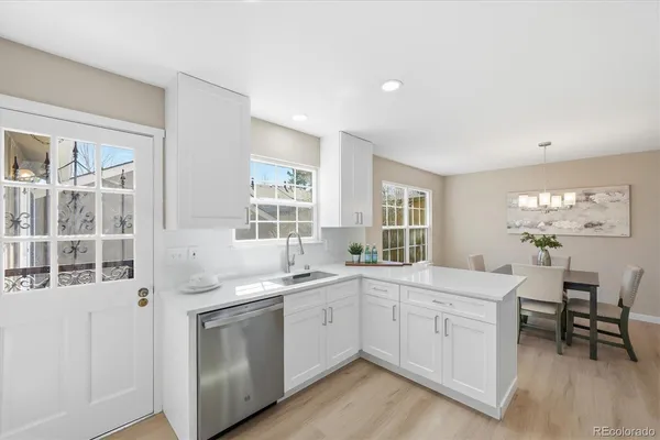 a kitchen with a sink stove and cabinets