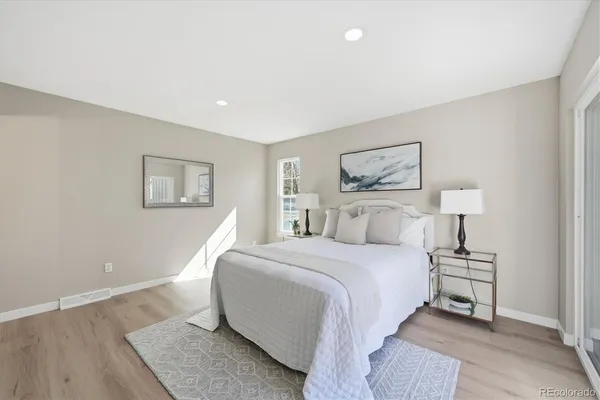 a bedroom with a bed and a painting on the wall