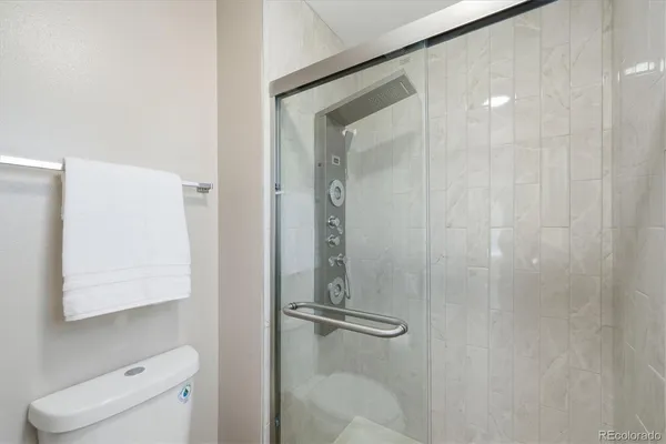 a bathroom with a shower a toilet and sink