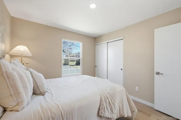 a bedroom with a bed and a window