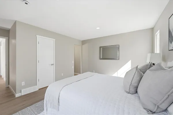 a bedroom with a bed and a night stand