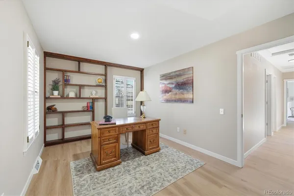 a view of a bedroom with furniture and window