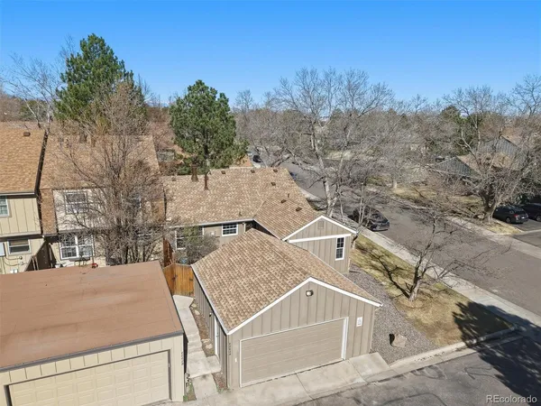 an aerial view of a house with a yard
