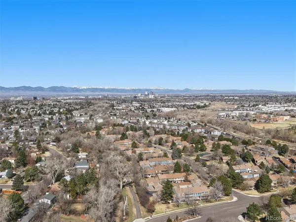 an aerial view of residential houses with city view