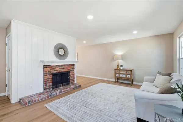 a living room with furniture and a fireplace