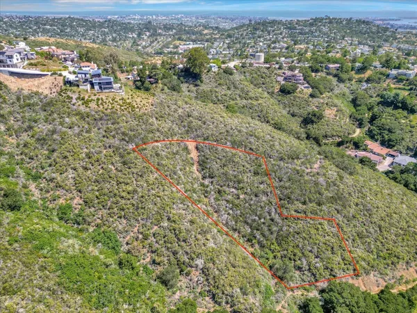 an aerial view of residential houses with city view