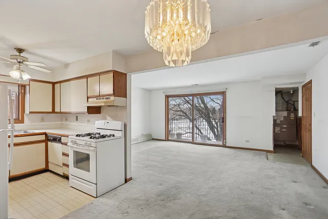 a kitchen with a stove and a white cabinets
