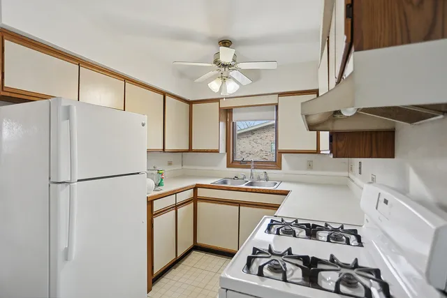 a kitchen with a sink stove and refrigerator