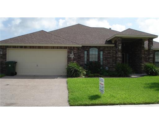 a black and white house with a yard