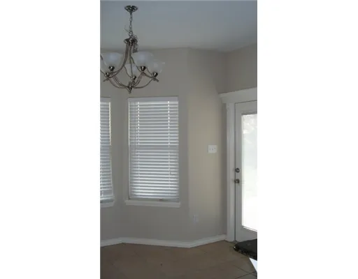 a view of a room with a ceiling fan and a window