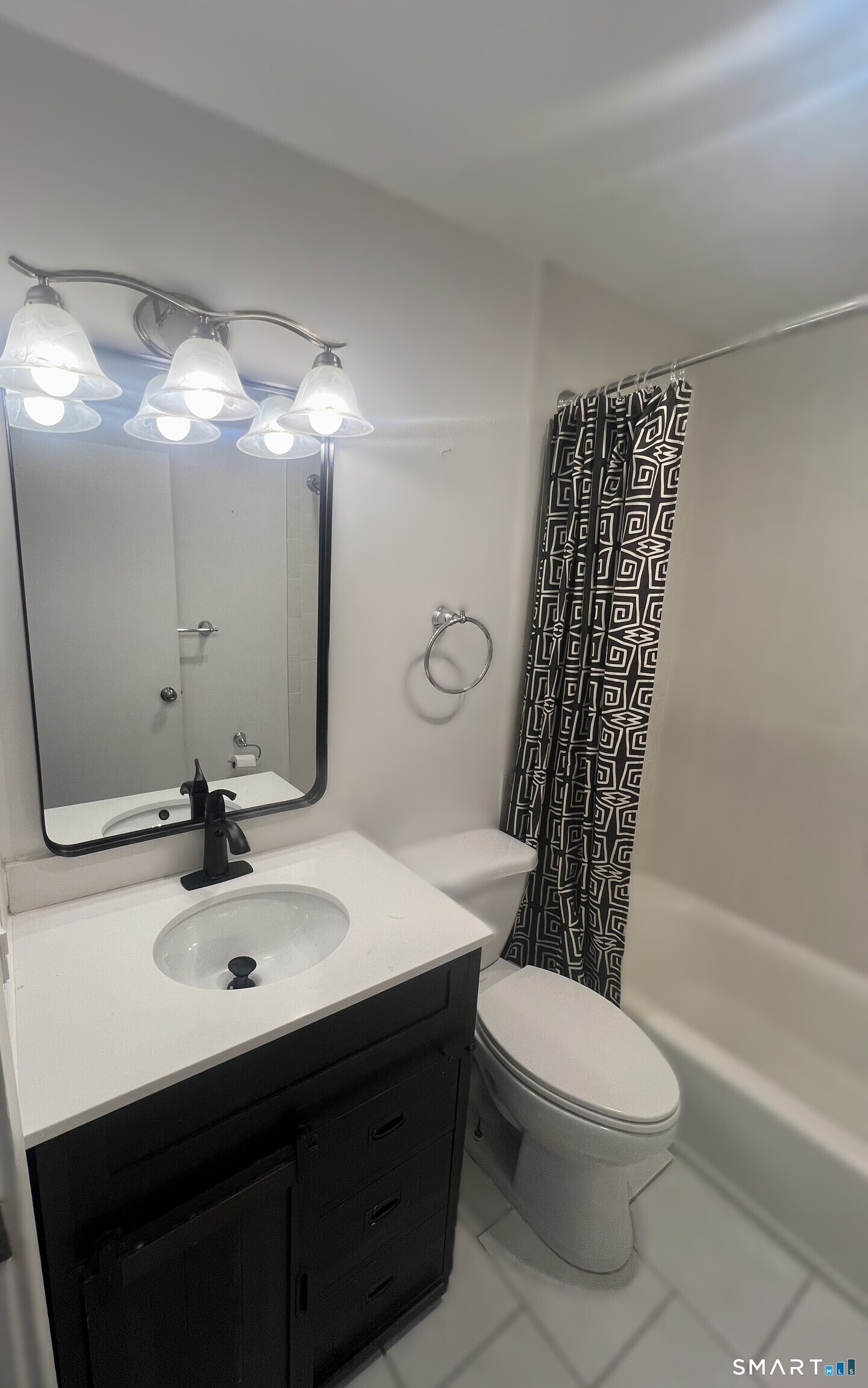 100 Hope Street, Unit 10 Stamford, CT 06906 - Photo 11 of 14 a bathroom with a sink a toilet a mirror a vanity and shower