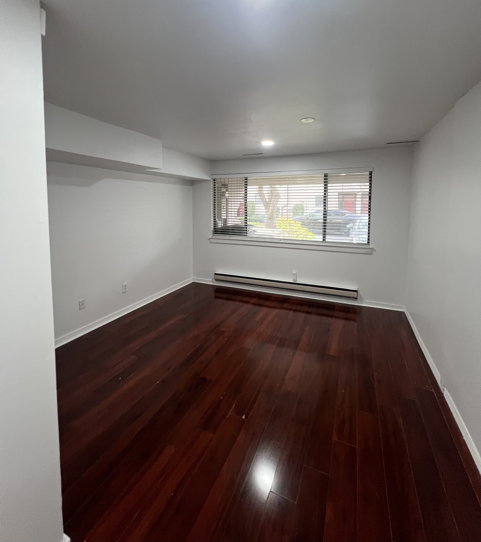 100 Hope Street, Unit 10 Stamford, CT 06906 - Photo 13 of 14 an empty room with wooden floor and windows