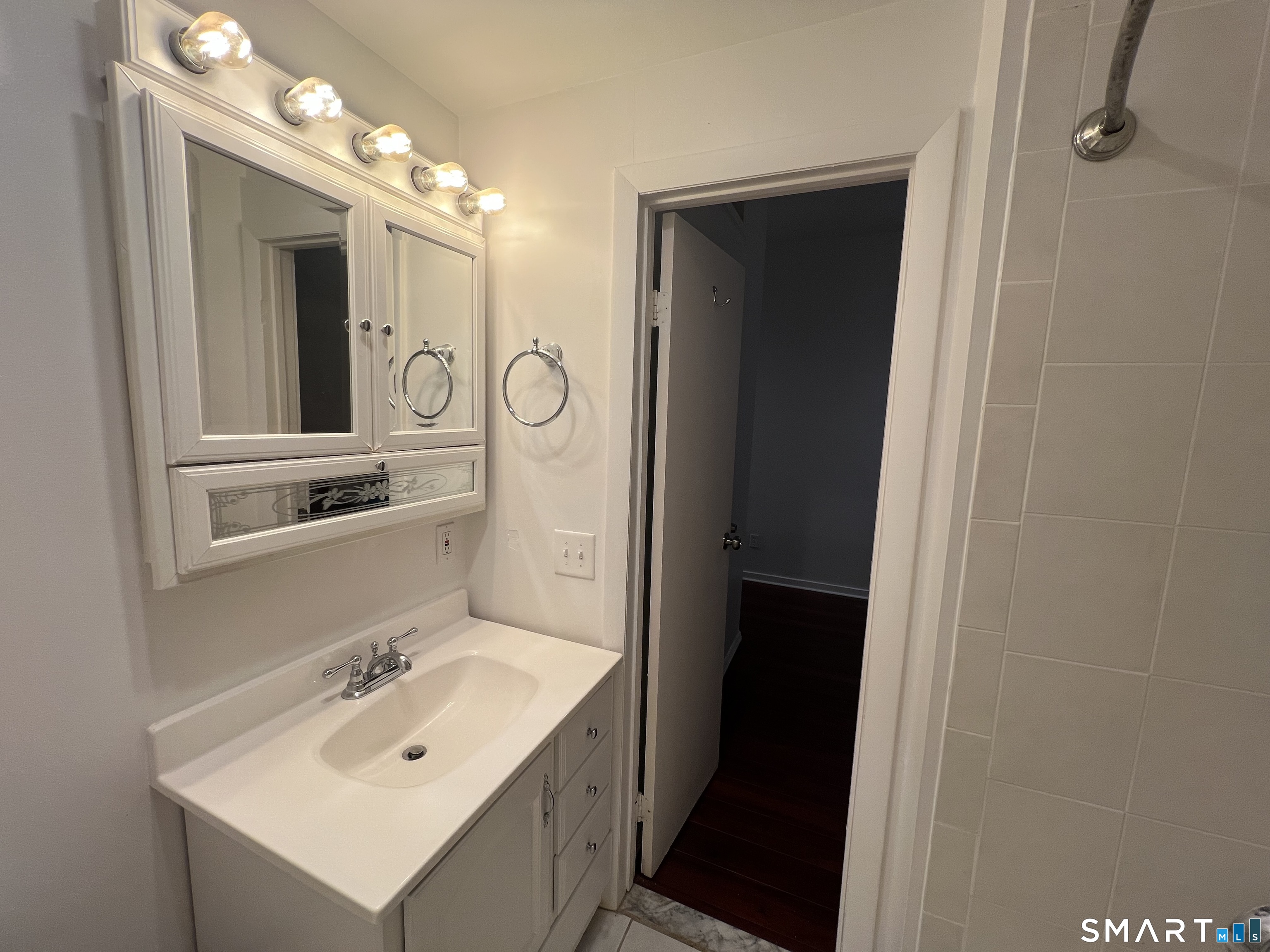 100 Hope Street, Unit 10 Stamford, CT 06906 - Photo 14 of 14 a bathroom with a sink mirror and vanity
