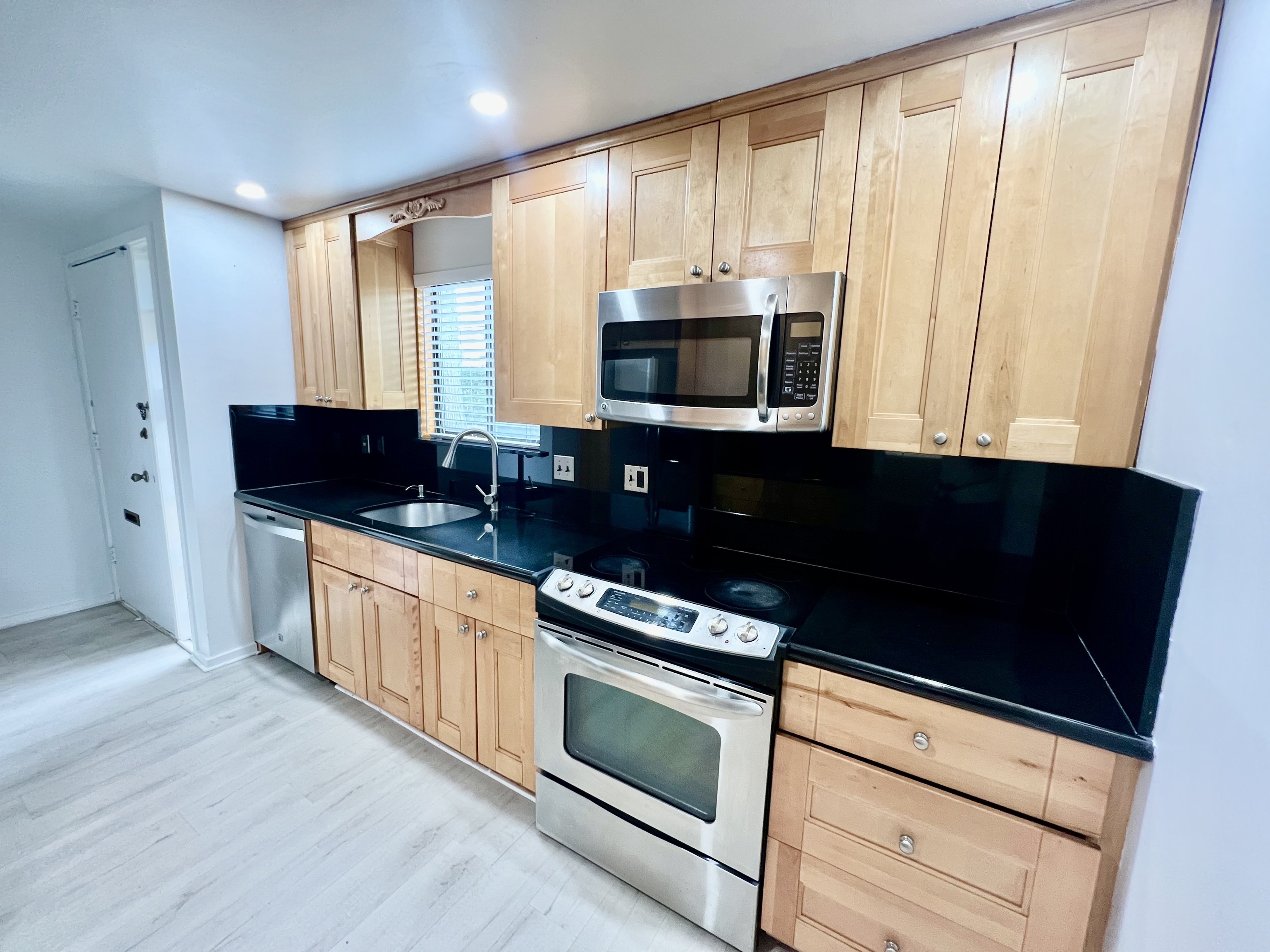 100 Hope Street, Unit 10 Stamford, CT 06906 - Photo 4 of 14 a kitchen with stainless steel appliances a stove microwave and sink