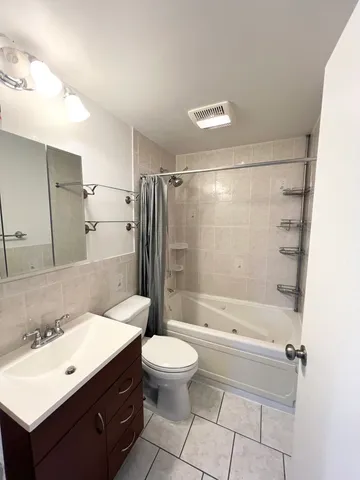 a bathroom with a sink mirror toilet and bathtub
